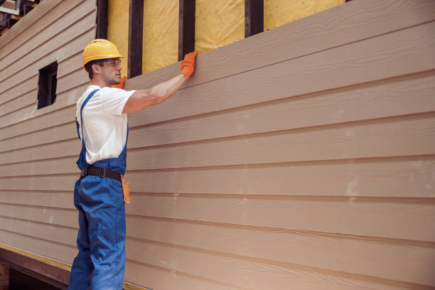 Siding contractor installing siding in Brooklyn, NY